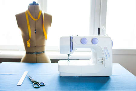 Tailor dummy with measuring tapes in fashion studio, close upの写真素材