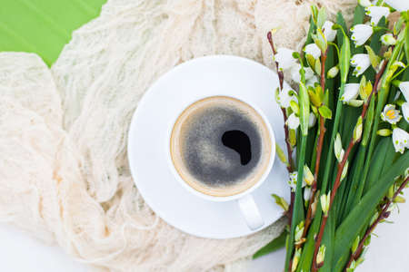 Bouquet White spring bellflowers and coffee cup on table in garden. Spring morning with coffee.の写真素材