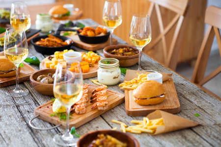 table with food and drink wine, Enjoying Dinning Eating Concept at the rustic wooden tableの写真素材