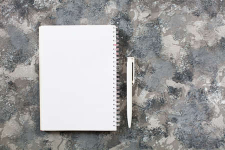Modern gray work office desk table with laptop, keyboard, smartphone and other business accessories, supplies with cup of coffee. Top view, flat lay.の写真素材