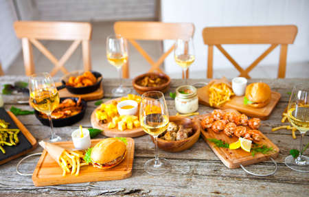 table with food and drink wine, Enjoying Dinning Eating Concept at the rustic wooden tableの写真素材