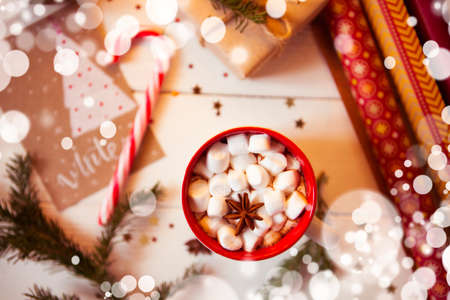 Cup of hot Chocolate drink with Marshmallows and cinnamon on wooden background with Christmas decorations. Winter time. Holiday concept, Selective focusの写真素材