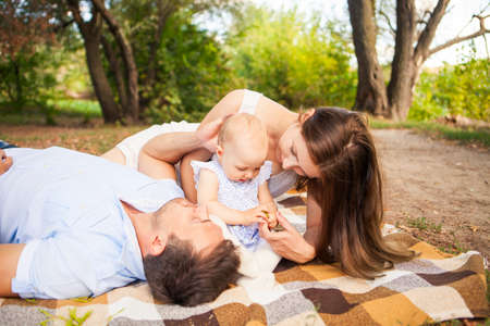 Happy young caucasian family spending time outdoor on a summer day, picnic in the park. Set