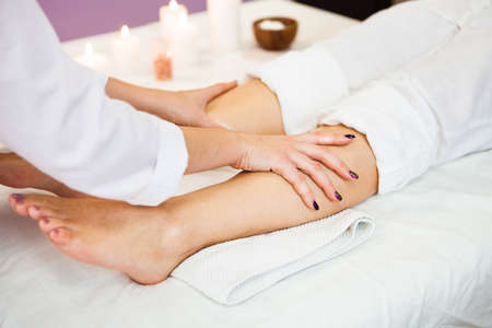 Beautiful young woman relaxing with hand massage at beauty spa salon. Close-up, Spa treatment. Ð¡oncept of health

の写真素材