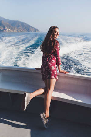 Happy young amazing woman wearing relaxing on the yacht in Cinque Terre, Italy, Ligurian Sea,...
