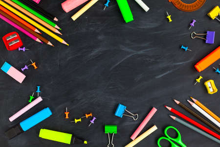 Back To School concept. School supplies on blackboard background, accessories for the schoolroom - pencils, scissors, chalk, markers. Ð¡opy space top viewの写真素材