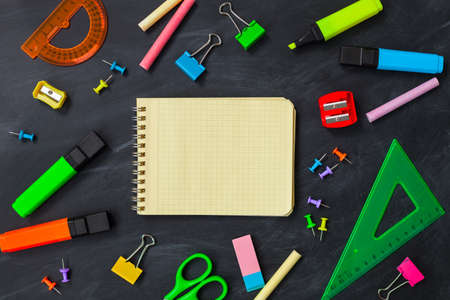 Back To School concept. School supplies on blackboard background, accessories for the schoolroom - pencils, notebooks, scissors, chalk, markers.  Ð¡opy space top viewの写真素材