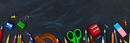 Back To School concept. School supplies on blackboard background, accessories for the schoolroom -...