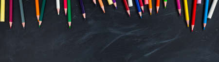 Back to School concept. Colorful pencils on blackboard background. Close up, flat lay, copy space,...