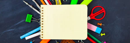Back To School concept. School supplies on blackboard background, accessories for the schoolroom -...