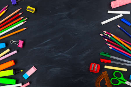 Back To School concept. School supplies on blackboard background, accessories for the schoolroom -...