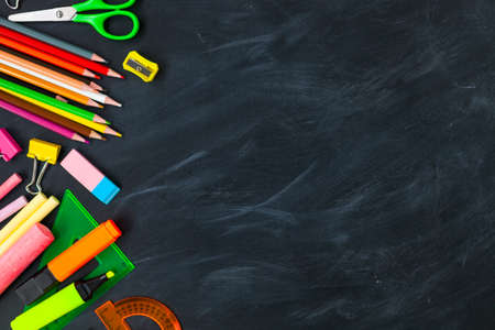 Back To School concept. School supplies on blackboard background, accessories for the schoolroom -...