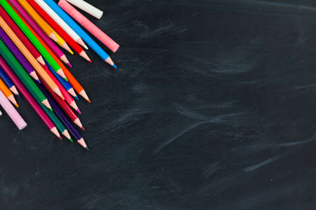 Back to School concept. Colorful pencils on blackboard background. Close up, flat lay, copy space, top view,の写真素材