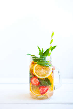 Fresh lemonade with summer fruits and berries on white backgroundの写真素材