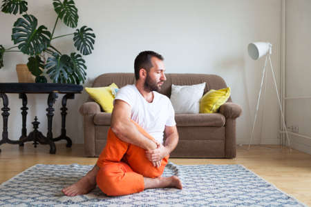 Man practicing yoga and meditation at home. A series of yoga poses. Lifestyle concept.の写真素材