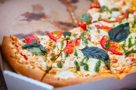 Hot tasty italian pizza with vegetables in box on wooden background.の写真素材