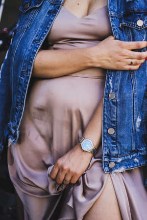 beautiful gentle female hands on the background of clothing or fabricの写真素材