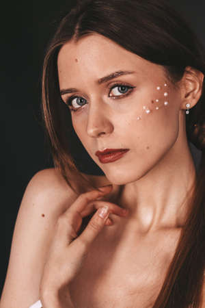 girl with bare shoulders. brunette. clavicle. makeupの写真素材