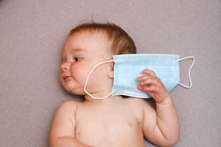 little boy with medical mask. baby, infant. pandemic, covid 19, epidemic
