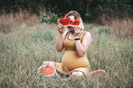pregnant girl with watermelon. summer picnic. summer rest. happy pregnancy.の写真素材