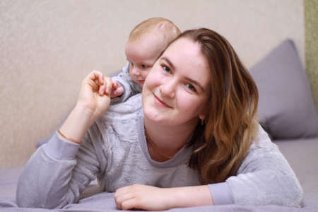 home photos of a young mother with a small child. Newborn boy. Cute, cozy photos with a baby.の写真素材