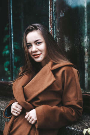 brunette girl with long hair. street style. Girl in coat