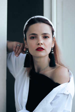 a woman in a dress and a white shirt, with a white hoop on the stairs with white doors. Frenchwoman,...
