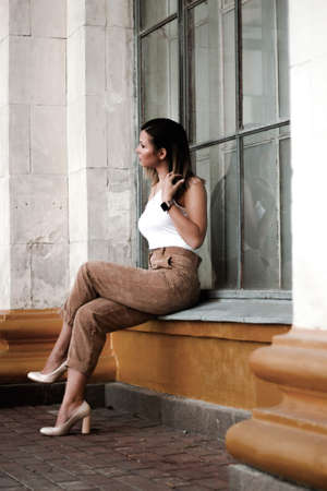 street style shot of a girl. photo of a young girl on the background of the building, columns.