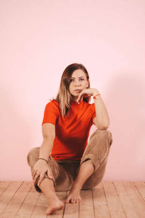 young thin girl in a knitted suit on a light background. Tenderness, femininity.の写真素材