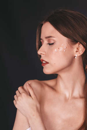 girl with bare shoulders. brunette. clavicle. makeupの写真素材