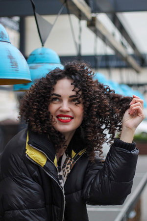 bright curly happy girl. smiling and emotional curly woman. afro-curlsの写真素材