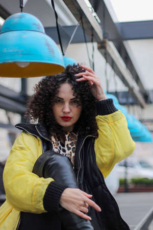 girl with ayro curls and bright makeup. interesting multinational appearance.