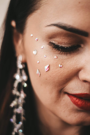 brunette girl with long massive earrings. costume jewelryの写真素材