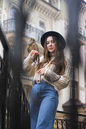 cute tender girl holding an owl on her hand.の写真素材