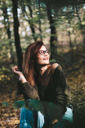 autumn photo session of a beautiful girl with dark hair in the forest.の写真素材