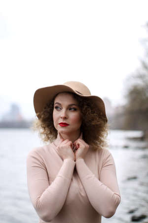 ugly curly girl with a hat in pastel colorsの写真素材
