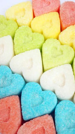 Colorful valentine hearts candy on white background.  Sweets hearts. Valentineâs day symbol. Festive treat. Valentine day background.の写真素材