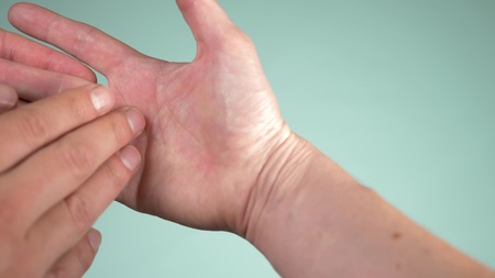 Close up. human hand and psychic or fortune, teller explain lines on palm. Palmistry concept. color backgroundの写真素材