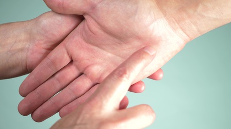 Close up. human hand and psychic or fortune, teller explain lines on palm. Palmistry concept. color backgroundの写真素材