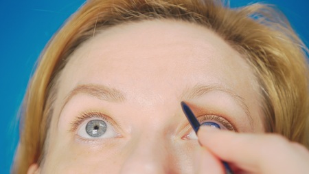 super close-up, woman paints eyebrow pencil for eyebrows. woman doing her makeupの写真素材