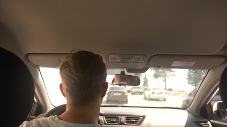 car jam on a busy road in a bright sunny day, view from the car, blur.