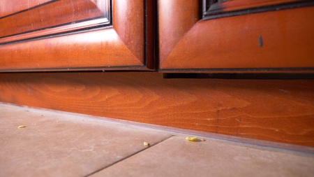 close-up dirt, dust, hair and leftovers on the kitchen floorの写真素材