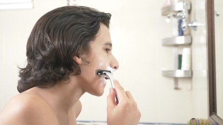 Teenager shaves first time, teenage boy applying shaving foam, skincare, cream, face, close-upの写真素材