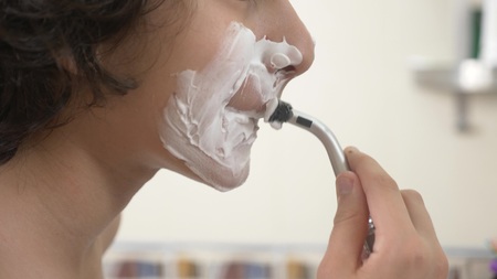 Teenager shaves first time, teenage boy applying shaving foam, skincare, cream, face, close-upの写真素材