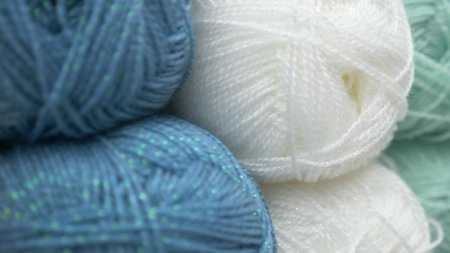 colorful threads. Knitting pattern of colorful yarn wool on shopfront. Knitting background. Knitting yarn for handmade winter clothes. Colorful background with yarn ball.の写真素材