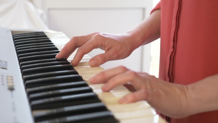 Musician playing synthesizer. the musician plays the piano. female hands play the synthesizer.の写真素材