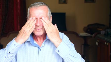 close-up portrait of an elderly man, his eyes hurt.