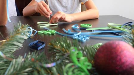 Creative paper Christmas tree. Quilling. childrens hands make quilting crafts for the new year. copy space,の写真素材