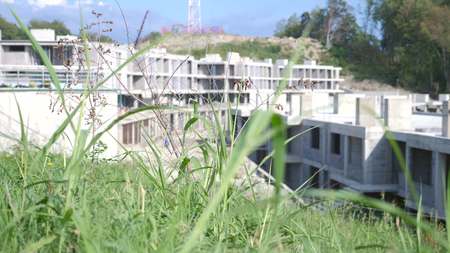 construction of modern luxury hotel on green mountain slope. Fashionable residential area and resort in ecologically clean area.の写真素材