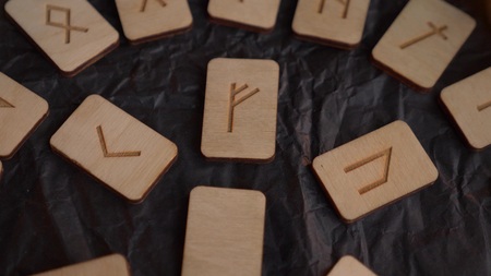 Wooden rune wheel. runic layout and candles.
